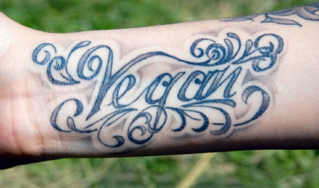 Vegan lettering tattoo on a forearm