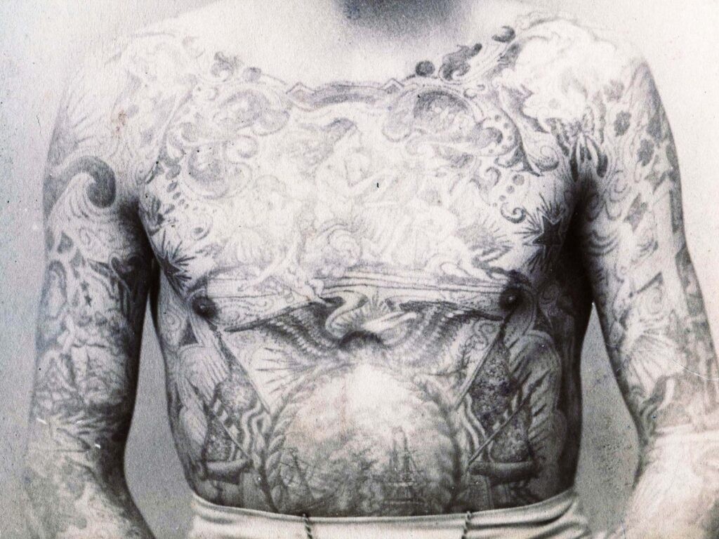 Historical photograph of a heavily tattooed man